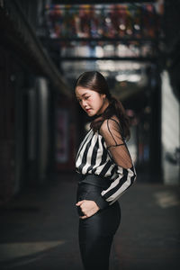 Portrait of young woman standing outdoors