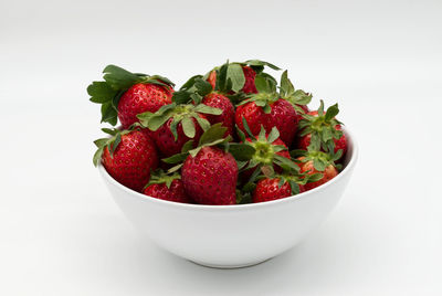 Close-up of strawberries in bowl against white background