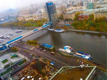 High angle view of illuminated city by river