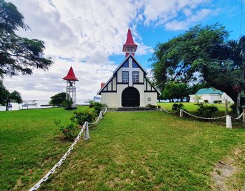 View of bell tower by building against sky