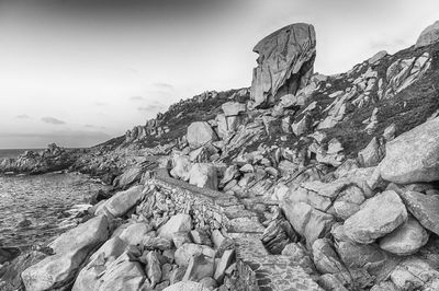 Scenic view of rocks in sea against sky