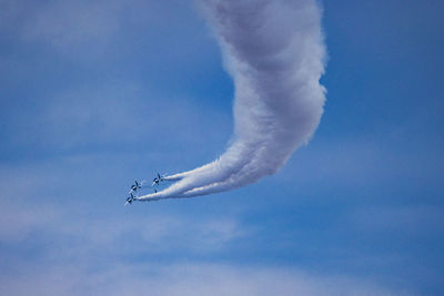 Low angle view of airplane flying against sky