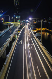 High angle view of light trails on highway at night