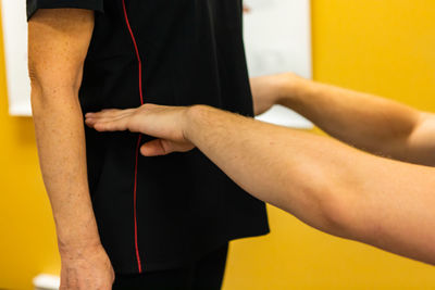Cropped hands of physical therapist examining patient