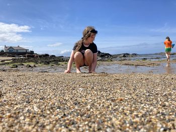 Full length of woman on beach against sky