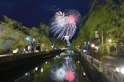 Firework display in city at night