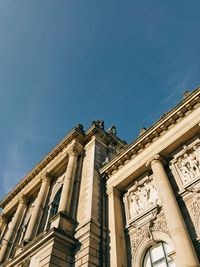 Low angle view of historical building against blue sky