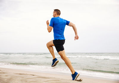 Full length of man running on beach