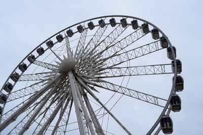 Low angle view of ferris wheel against sky