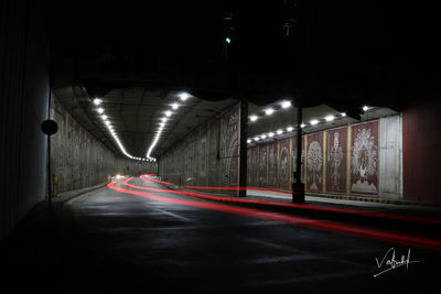 Light trails on road in illuminated tunnel