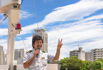 Man standing against buildings in city against sky