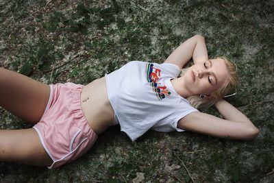 High angle view of woman lying down on land