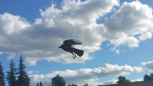 Low angle view of statue against cloudy sky