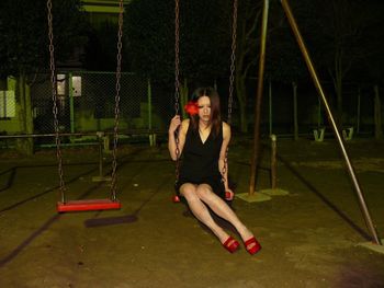 Woman sitting on swing