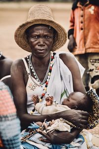 Midsection of woman sitting at market stall