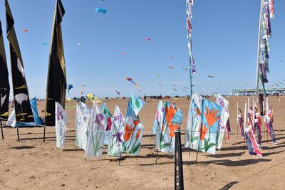 Clothes drying on beach against clear sky