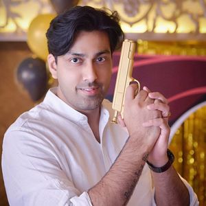 Portrait of young man holding camera