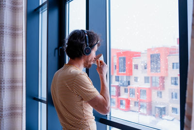 Woman looking through window