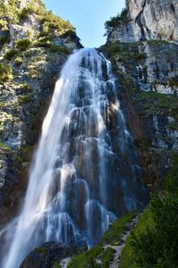 Low angle view of waterfall in forest
