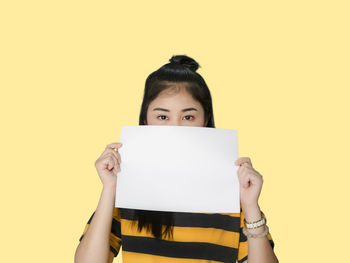 Portrait of woman wearing mask against white background