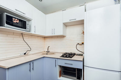 Modern white kitchen with gas stove