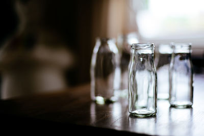 Close-up of empty glass bottles on table