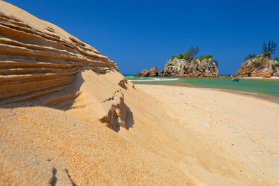 Rock formations in desert against clear blue sky