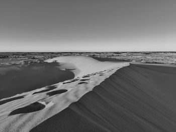 Footprint in hill of sand dunes