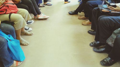 Low section of men sitting on floor