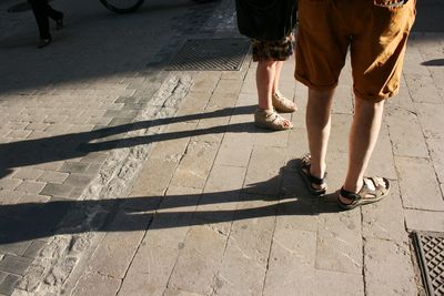 Low section of people standing on road