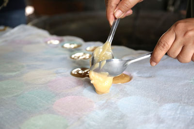 Midsection of person preparing food on table