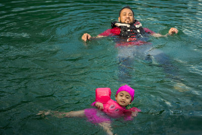 Portrait of a smiling girl swimming in sea