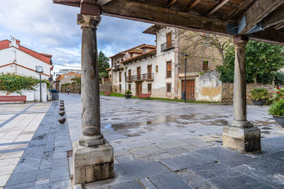 Footpath amidst buildings in city