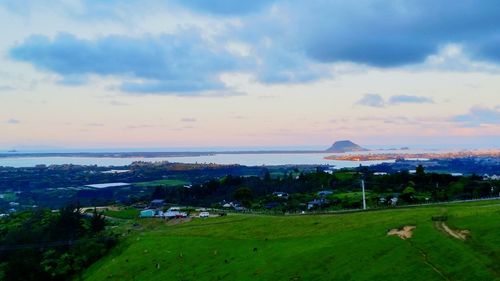 Scenic view of sea and cityscape against sky