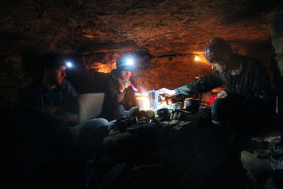 People sitting in illuminated room