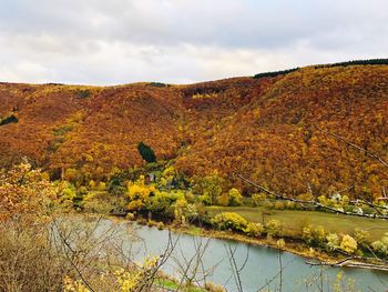 Scenic view of river against sky during autumn