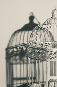 Low angle view of metal in cage against wall