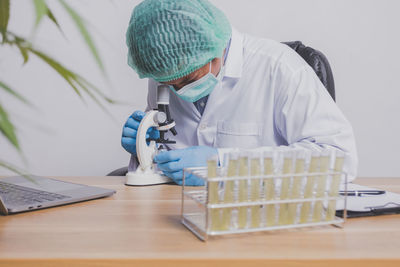 Female doctor examining chemical in laboratory