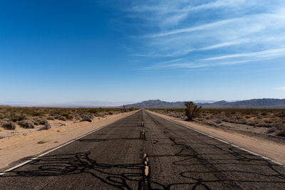 Empty road along countryside landscape