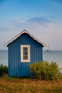 House on beach against sky