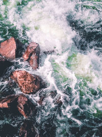 Water flowing through rocks in sea