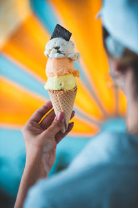 Close-up of hand holding ice cream cone