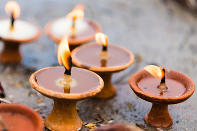 High angle view of lit tea light candles