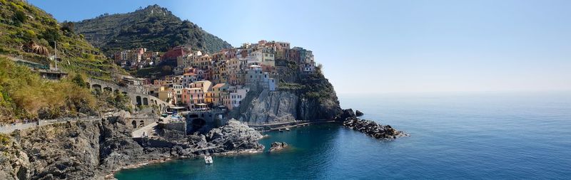 Panoramic view of sea and buildings against sky