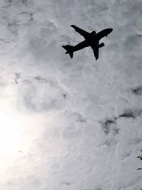 Low angle view of airplane flying in sky