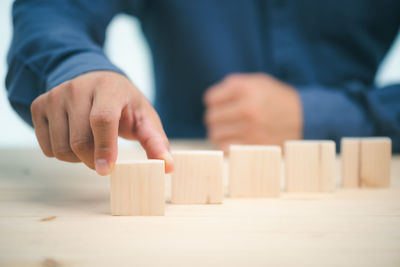 Midsection of man playing with toy on table