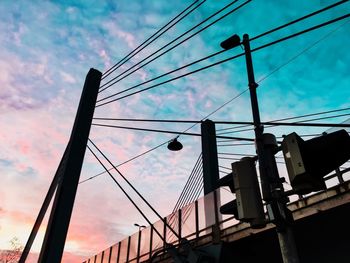 Low angle view of electricity pylon against sky