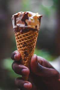 Close-up of hand holding ice cream cone