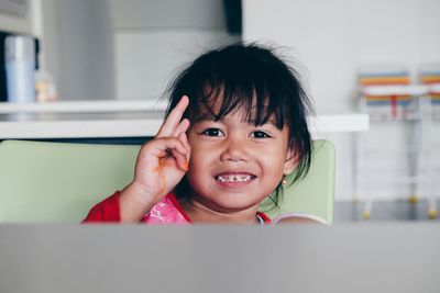 Close-up portrait of smiling boy at home