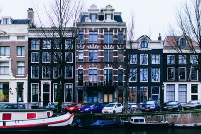 Boats in canal with buildings in background